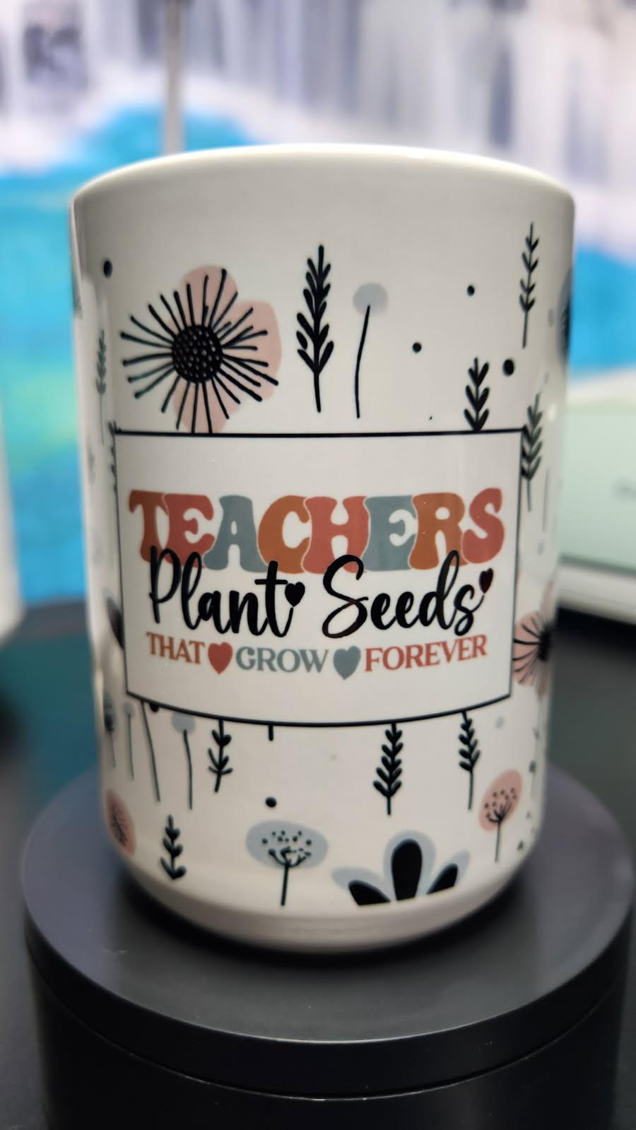 White mug with floral designs and text on a black surface