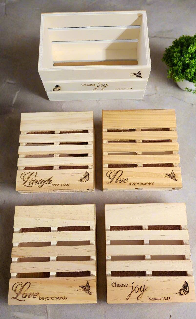 four pallet coasters with cork backing and a crate that has the text 'choose joy' etched on the front.