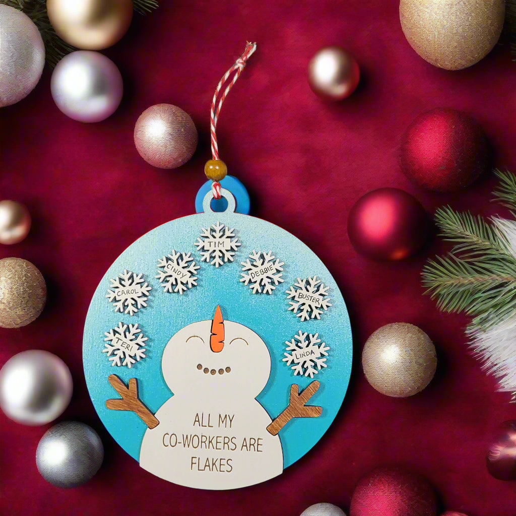 snowman ornament with snowflakes and the text 'all of my coworkers are flakes'