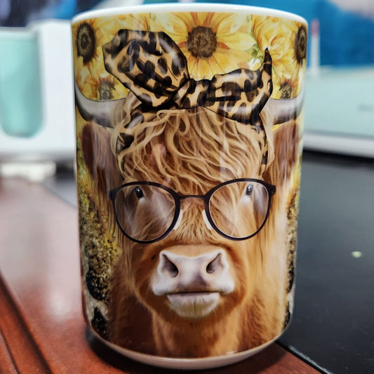 Highland cow with glasses and a bow and sunflowers in the back - one classy Heffer with glasses - sublimated 15oz mug -dishwasher and microwave safe.