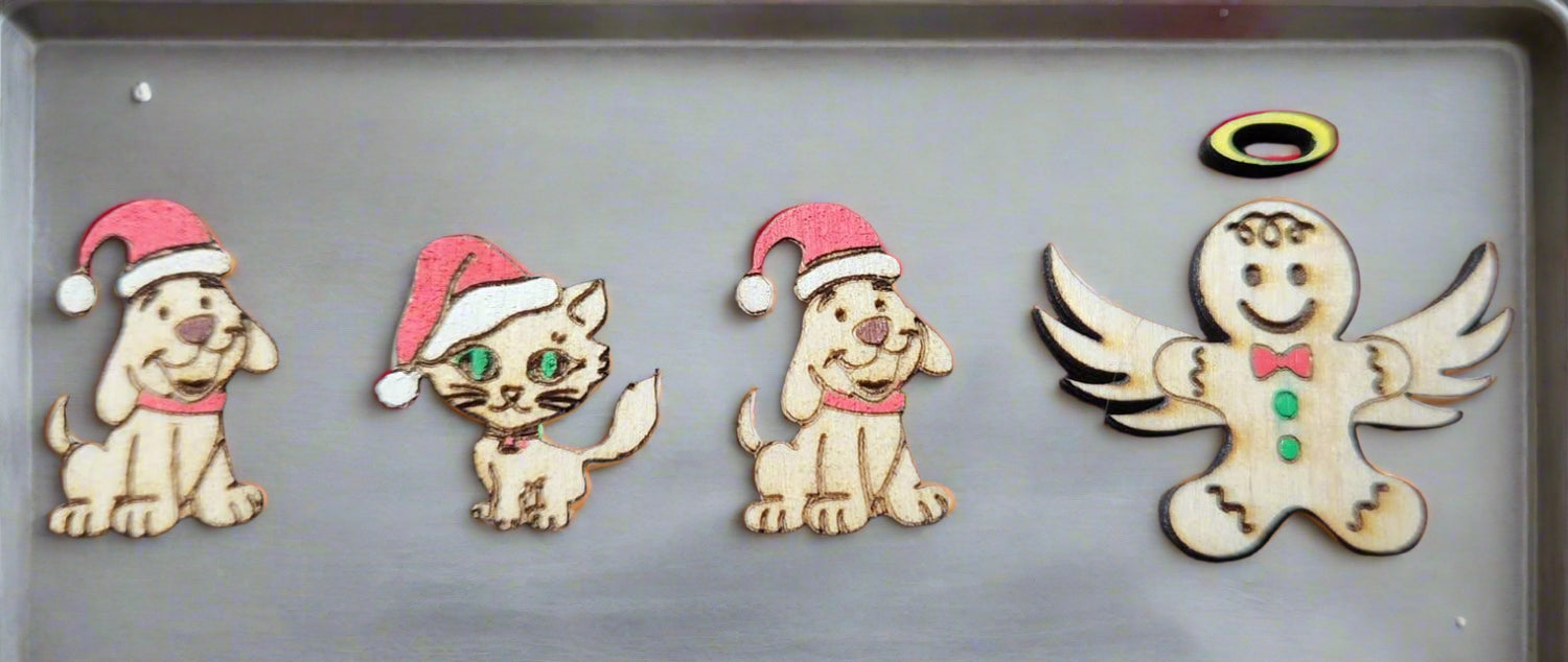 more additions to the gingerbread family on a cookie sheet