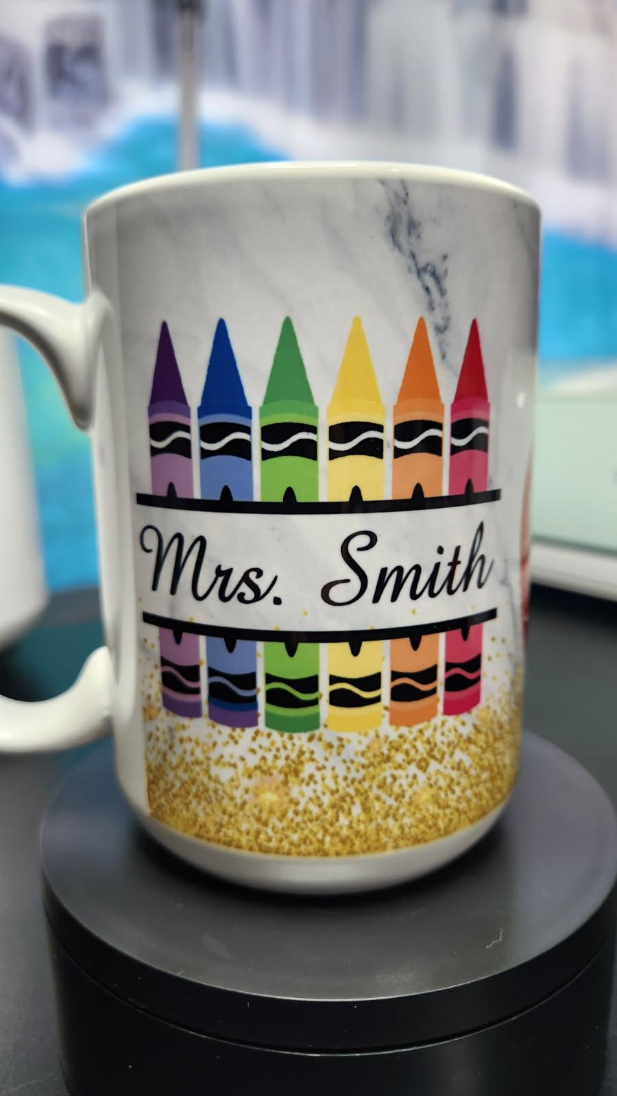 Mug with colorful crayon design and 'Mrs. Smith' text on a blurred background