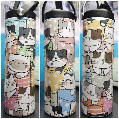 Three water bottles with cat-themed designs on a blurred background
