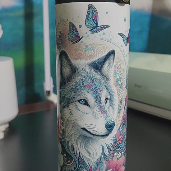 blue and pink butterflies and flowers surrounding a wolf